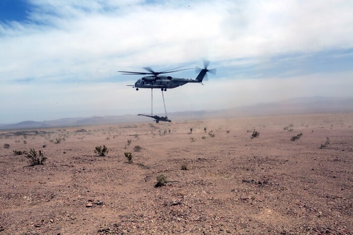 A Ch-53 super stallion helicopter lifts a M777A2 lightweight howitzer during Exercise Desert Scimitar at Marine Corps Air Ground Combat Center Twentynine Palms, Calif., May 8 2014. Desert Scimitar is a two-week, combined-element exercise to prepare Marines for deployments.  The Ch-53 is able to transport a howitzer quickly to locations that would otherwise be inaccessible. (U.S. Marine Corps photo by Lance Cpl. Ashton Buckingham)