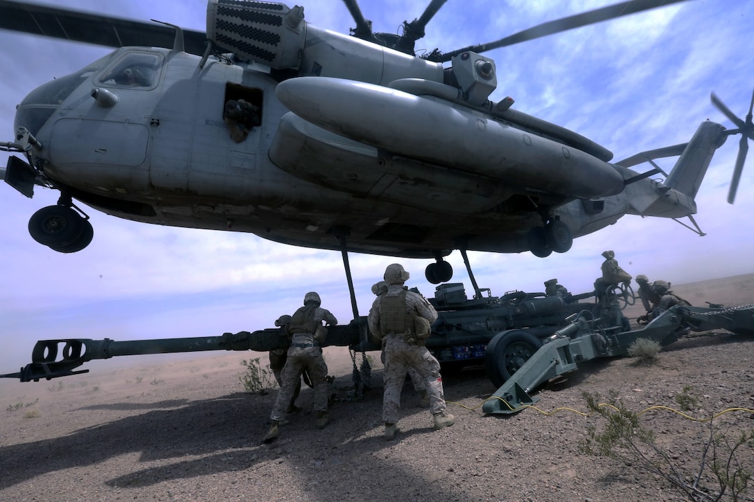 Marines with Combat Logistics Battalion 1 hook a M777A2 lightweight howitzer up to a Ch-53 super stallion helicopter during Exercise Desert Scimitar at Marine Corps Air Ground Combat Center Twentynine Palms, Calif., May 8 2014. Desert Scimitar is a two-week, combined-element exercise to prepare Marines for deployments.  The CH-53 is able to transport a howitzer quickly to locations that would otherwise be inaccessible. (U.S. Marine Corps photo by Lance Cpl. Ashton Buckingham)