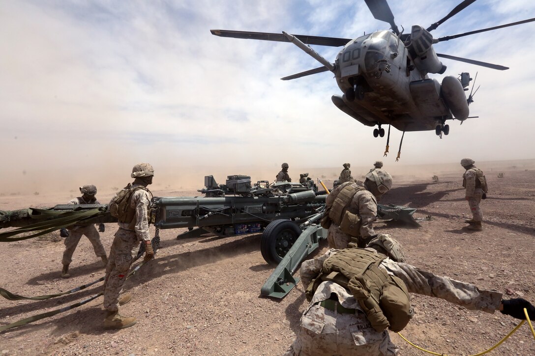 Marines with Combat Logistics Battalion 1 prepare to hook a M777A2 lightweight howitzer up to a Ch-53 super stallion helicopter during Exercise Desert Scimitar at Marine Corps Air Ground Combat Center Twentynine Palms, Calif., May 8 2014. Desert Scimitar is a two-week, combined-element exercise to prepare Marines for deployments.  The Ch-53 is able to transport a howitzer quickly to locations that would otherwise be inaccessible. (U.S. Marine Corps photo by Lance Cpl. Ashton Buckingham)
