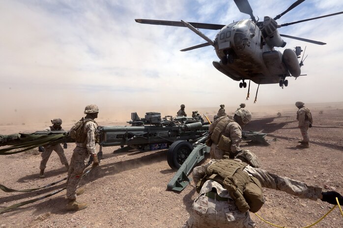 Marines with Combat Logistics Battalion 1 prepare to hook a M777A2 lightweight howitzer up to a Ch-53 super stallion helicopter during Exercise Desert Scimitar at Marine Corps Air Ground Combat Center Twentynine Palms, Calif., May 8 2014. Desert Scimitar is a two-week, combined-element exercise to prepare Marines for deployments.  The Ch-53 is able to transport a howitzer quickly to locations that would otherwise be inaccessible. (U.S. Marine Corps photo by Lance Cpl. Ashton Buckingham)