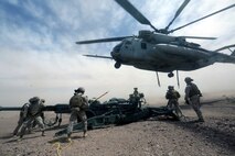 Marines with Combat Logistics Battalion 1 prepare to hook a M777A2 lightweight howitzer up to a Ch-53 super stallion helicopter during Exercise Desert Scimitar at Marine Corps Air Ground Combat Center Twentynine Palms, Calif., May 8 2014. Desert Scimitar is a two-week, combined-element exercise to prepare Marines for deployments.  The Ch-53 is able to transport a howitzer quickly to locations that would otherwise be inaccessible. (U.S. Marine Corps photo by Lance Cpl. Ashton Buckingham)