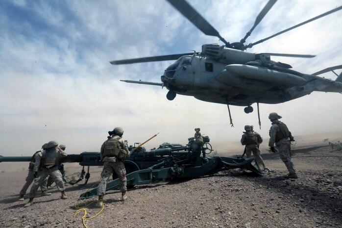 Marines with Combat Logistics Battalion 1 prepare to hook a M777A2 lightweight howitzer up to a Ch-53 super stallion helicopter during Exercise Desert Scimitar at Marine Corps Air Ground Combat Center Twentynine Palms, Calif., May 8 2014. Desert Scimitar is a two-week, combined-element exercise to prepare Marines for deployments.  The Ch-53 is able to transport a howitzer quickly to locations that would otherwise be inaccessible. (U.S. Marine Corps photo by Lance Cpl. Ashton Buckingham)