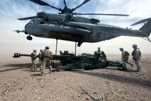 Marines with Combat Logistics Battalion 1 hook a M777A2 lightweight howitzer up to a Ch-53 super stallion helicopter during Exercise Desert Scimitar at Marine Corps Air Ground Combat Center Twentynine Palms, Calif., May 8 2014. Desert Scimitar is a two-week, combined-element exercise to prepare Marines for deployments.  The Ch-53 is able to transport a howitzer quickly to locations that would otherwise be inaccessible. (U.S. Marine Corps photo by Lance Cpl. Ashton Buckingham)