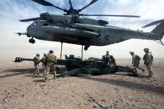 Marines with Combat Logistics Battalion 1 hook a M777A2 lightweight howitzer up to a Ch-53 super stallion helicopter during Exercise Desert Scimitar at Marine Corps Air Ground Combat Center Twentynine Palms, Calif., May 8 2014. Desert Scimitar is a two-week, combined-element exercise to prepare Marines for deployments.  The Ch-53 is able to transport a howitzer quickly to locations that would otherwise be inaccessible. (U.S. Marine Corps photo by Lance Cpl. Ashton Buckingham)