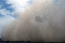 A Ch-53 super stallion helicopter approaches a M777A2 lightweight howitzer during Exercise Desert Scimitar at Marine Corps Air Ground Combat Center Twentynine Palms, Calif., May 8 2014. Desert Scimitar is a two-week, combined-element exercise to prepare Marines for deployments.  The Ch-53 is able to transport a howitzer quickly to locations that would otherwise be inaccessible. (U.S. Marine Corps photo by Lance Cpl. Ashton Buckingham)