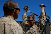 Petty Officer 2nd Class Daniel Wagner, left, a hospital corpsman with Headquarters Battalion, 1st Marine Division, monitors Lance Cpl. Aaron Brown, a motor transport operator with the battalion, during a physical therapy session at Marine Corps Air Ground Combat Center Twentynine Palms, Calif., May 14, 2014. Wagner routinely improvises medical treatment while in the field. He understands the work tempo of the Marines requires the battalion aid station to be creative when continuing treatment for their patients.