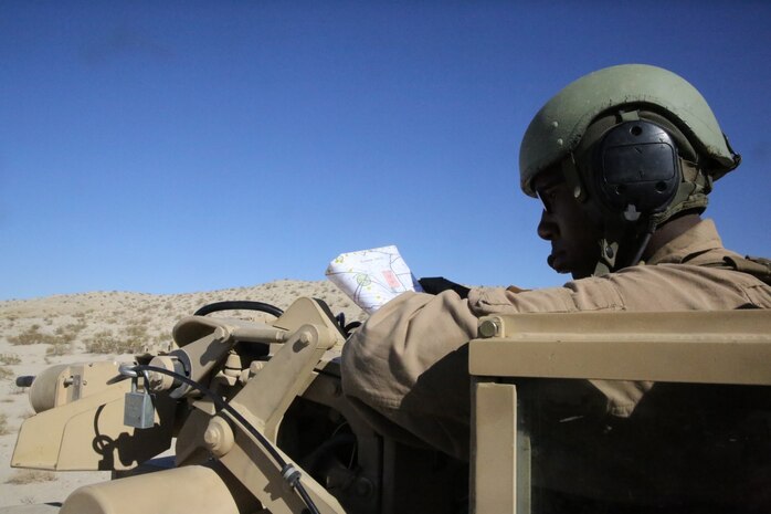 Sgt. Maurice Rice, tank commander, Alpha Company, 1st Tank Battalion, navigates an M1A1 abrams main battle tank in support of Exercise Desert Scimitar 2014 aboard Marine Corps Air Ground Combat Center Twentynine Palms, Calif., May 13, 2014. Rice, from Chicago, assumes leadership and responsibility for the vehicle and crew. He also give the command to fire the main gun and ensures everyone understands the mission. (U.S. Marine Corps photo by Cpl. Christopher J. Moore/Released)