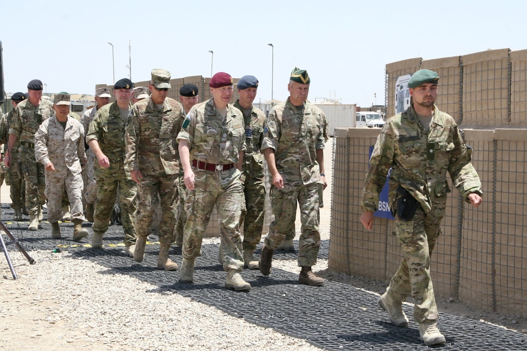 Key coalition partners with International Security Assistance Force march in formation for the Danish Contingent end of mission ceremony aboard Camp Bastion, Afghanistan, May 20, 2014. This year marked the 17th rotation and final deployment to Afghanistan for DANCON. Since their first mission began, more than 18,000 Danish soldiers have deployed to the country.
