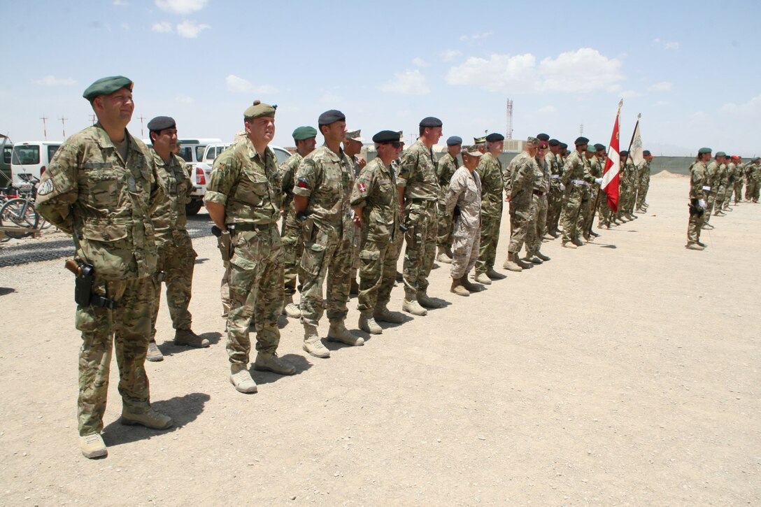 Key coalition partners with International Security Assistance Force stand in formation during the Danish Contingent end of mission ceremony aboard Camp Bastion, Afghanistan, May 20, 2014. This year marked the 17th rotation and final deployment to Afghanistan for DANCON. Since their first mission began, more than 18,000 Danish soldiers have deployed to the country.