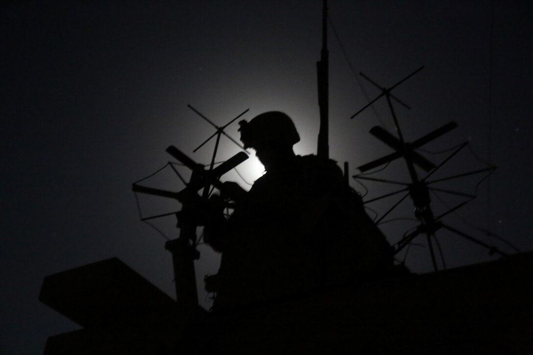 Corporal Stephen Hornbeck, field radio operator, Weapons Company, 1st Battalion, 7th Marine Regiment, and a native of Chicago, works on satellite communication during a mission in Helmand province, Afghanistan, May 12, 2014. The company disrupted Taliban fighters to aid in the retrograde of Sturga II, a British base northeast of Lashkar Gah. The battalion has conducted dozens of missions since they assumed their battlespace March 15, but this was their first combat engagement with insurgents since their arrival in country.