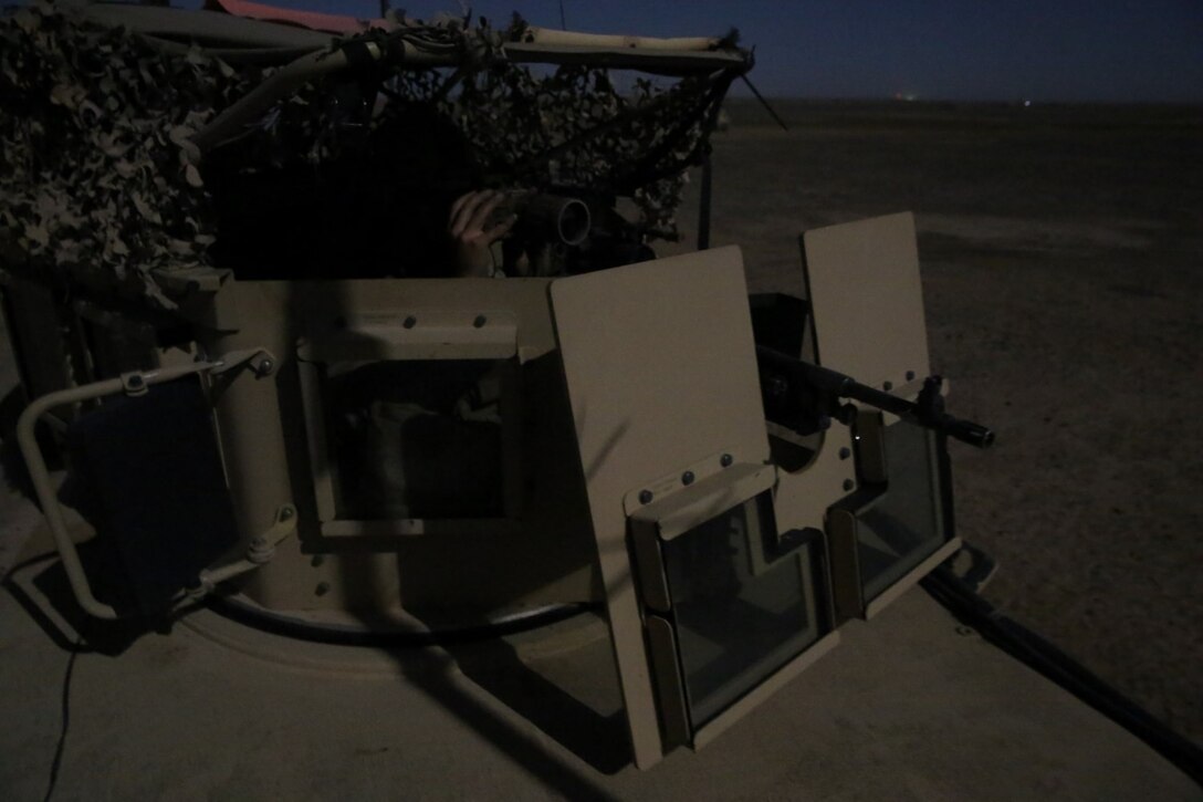 Lance Cpl. Derl Curry III, joint forward observer, Weapons Company, 1st Battalion, 7th Marine Regiment, and a native of Raleigh, North Carolina, uses binoculars while providing security during a mission in Helmand province, Afghanistan, May 12, 2014. The company disrupted Taliban fighters to aid in the retrograde of Sturga II, a British base northeast of Lashkar Gah. The battalion has conducted dozens of missions since they assumed their battlespace March 15, but this was their first combat engagement with insurgents since their arrival in country.