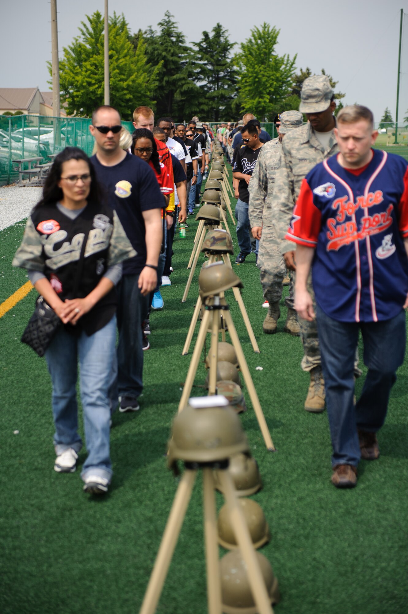 Airmen from the 8th Mission Support Group participate in the silent walk during the 2014 Sexual Assault Prevention and Response down day at Kunsan Air Base, Republic of Korea, May 22, 2014. The silent walk displayed the 99 sexual assaults reported at Kunsan over the past 10 years. (U.S. Air Force photo by Senior Airman Armando A. Schwier-Morales/Released)