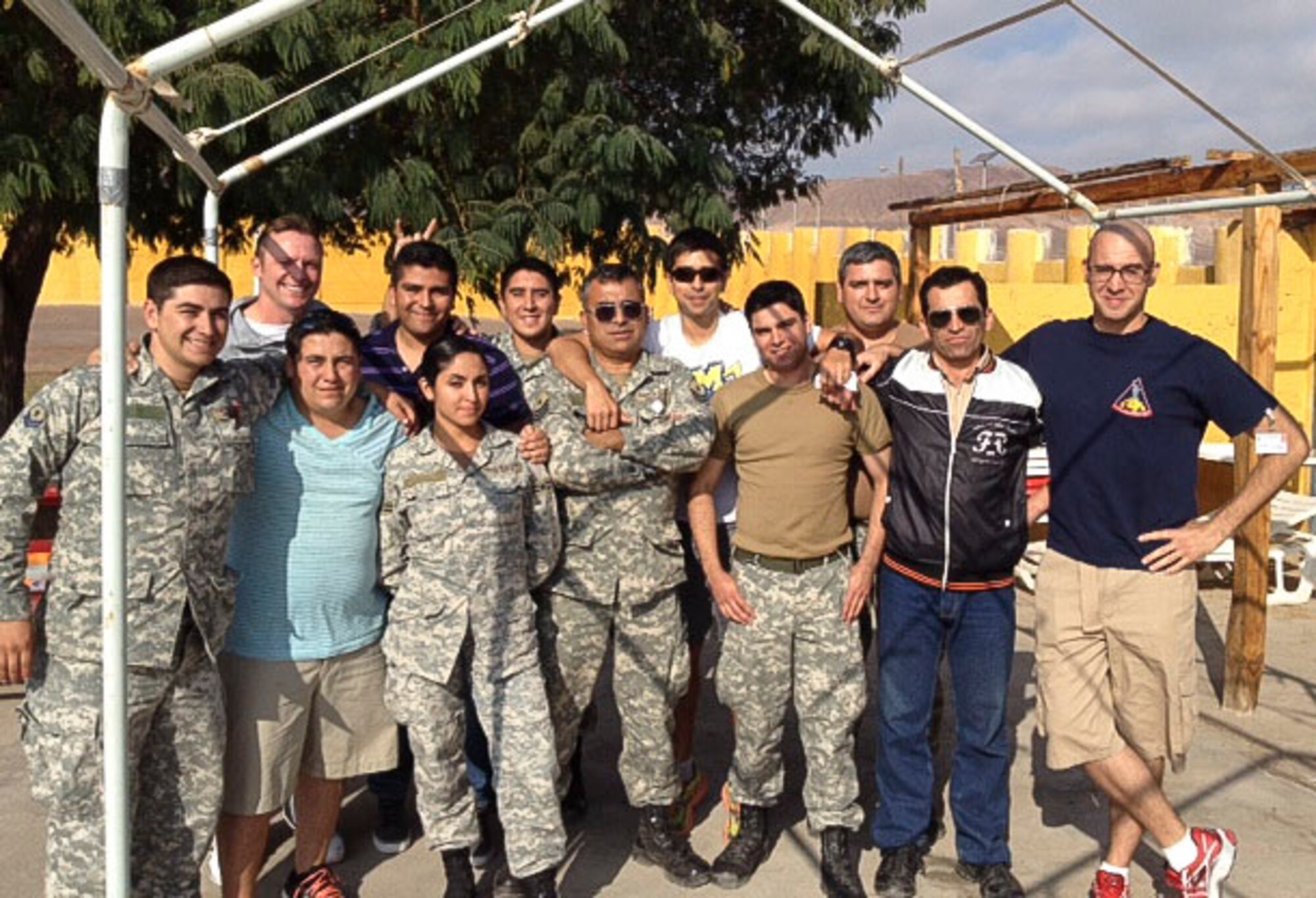 Master Sgt. Jeremy Jacobs, 12th Air Force (Air Forces Southern) Tactical Aircraft Manager, and Staff Sgt. Nicholas Filip, 355th Operational Support Squadron Aircrew Flight Equipment Technician, pose for a photo with members of the Chilean Air Force during a subject matter expert exchange.