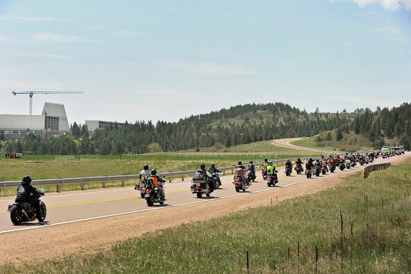 Military and civilian law enforcement members, including Academy Airmen, ride toward the Cadet Chapel March 22 during the 2014 National Police Week Motorcycle Run. The event was designed to show respect for law enforcement officials across the country who have died in the line of duty. (Sarah Chambers/U.S. Air Force photo)