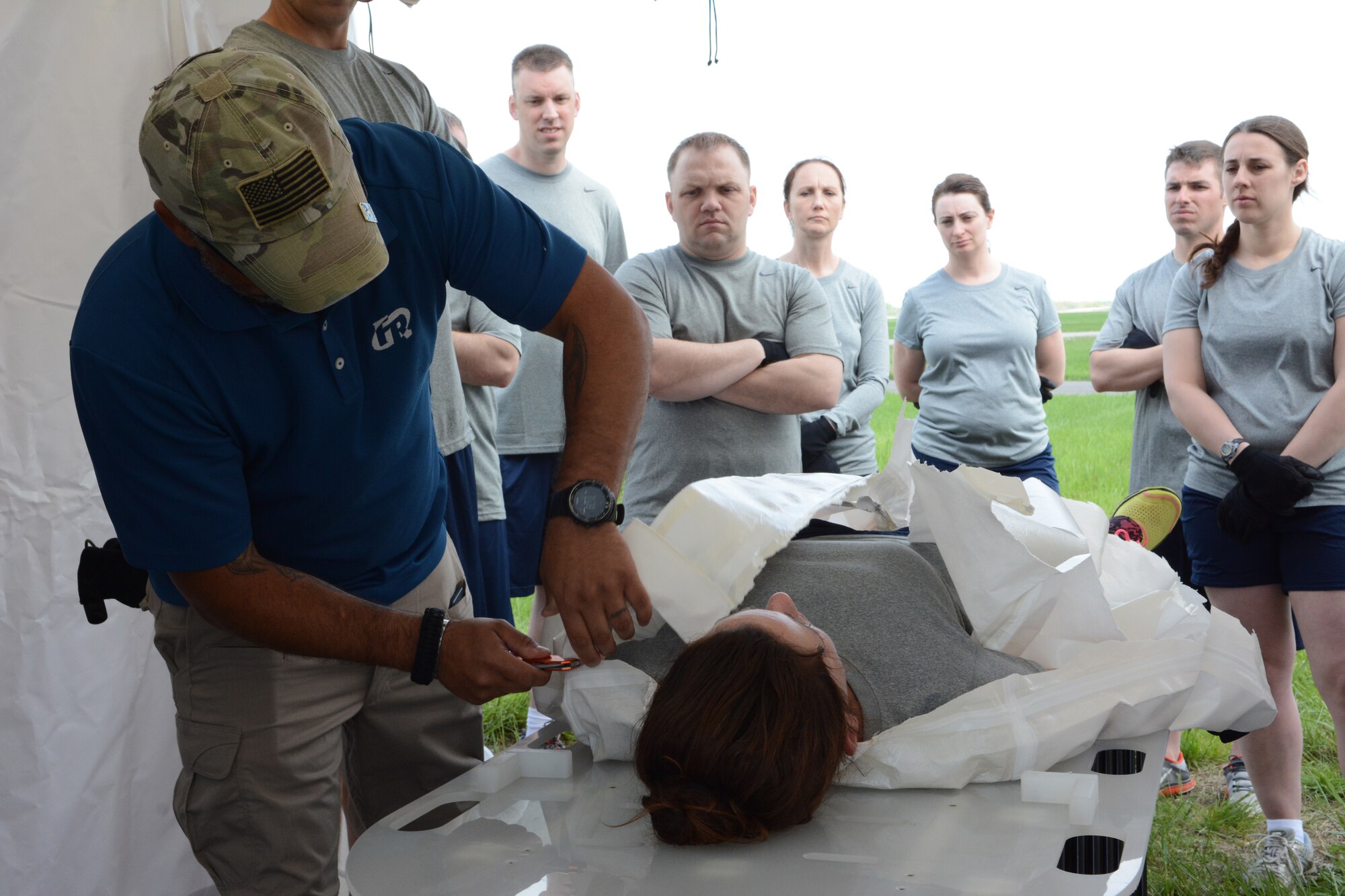 Airmen from across the base watch their instructor during a 976A Patient Decontamination certification at the 115th Fighter Wing in Madison, Wis., May 22, 2014. The 976A team is made up of people from different areas of the base, so that base personnel affected by a chemical situation don’t have to wait for the firefighters and security forces units to be available. If an actual emergency occurred, the firefighters and security forces Airmen would be required elsewhere. (Air National Guard photo by Senior Airman Andrea F. Liechti)