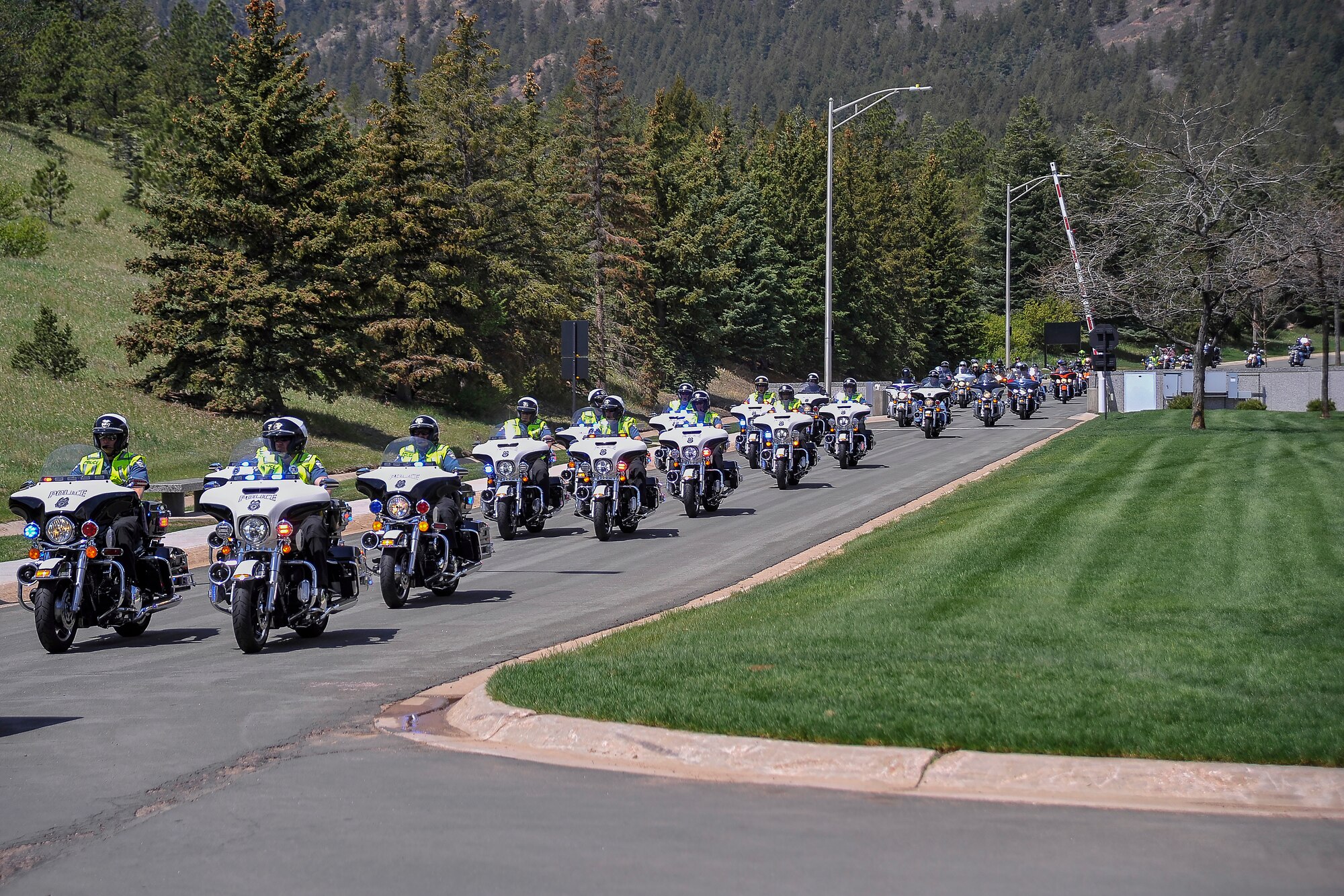 Dozens of motorcycle riders head toward Harmon Hall March 22 during the 2014 National Police Week Motorcycle Run. The run took the riders through Cheyenne Air Force Station, Fort Carson, Peterson Air Force Base, Schriever AFB and the Academy, and was meant to show respect for military and civilian law enforcement officers killed in the line of duty.  (Liz Copan/U.S. Air Force photo) 