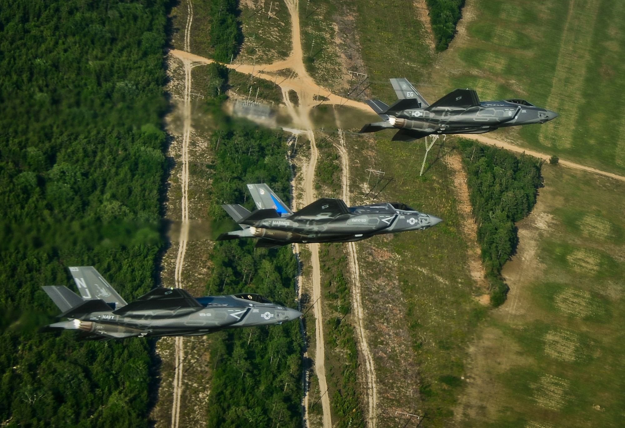 A Navy F-35C, a Marine Corps F-35B, and an Air Force F-35A Lightning II participate in a training sortie together May 21, near Eglin Air Force Base, Fla. All three variants of the fifth generation multirole stealth fighter are hosted at Eglin by the 33rd Fighter Wing. The wing’s F-35 Integrated Training Center at Eglin surpassed 5,000 combined training sorties May 28, contributing more than a third of all sorties in the Department of Defense’s F-35 program. The F-35 is designed with the stealth, electronic warfare, and multi-spectral fused sensor capabilities, which will increase lethality and survivability in a contested environment. (U.S. Air Force photo/Staff Sgt. Katerina Slivinske)