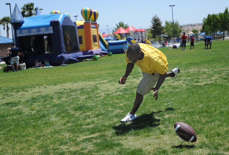 Staff Sgt. Willis, Creech Non-Commissioned Officer Council President, drops an interception during a football game at the 2014 Creech Summer Bash event at Lone Mountain Park May 19, 2014. The Summer Bash is an annual Creech resiliency event promoting family, fun, and camaraderie. (U.S. Air Force photo by Senior Master Sgt. C.R.)