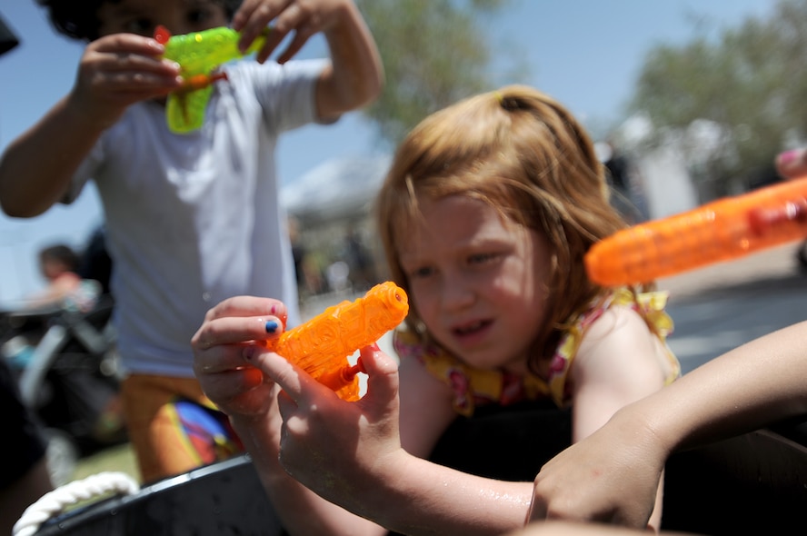 Chloe Winterbottom arms her water gun during the 2014 Creech Summer Bash event at Lone Mountain Park May 19, 2014. The Summer Bash is an annual Creech resiliency event promoting family, fun, and camaraderie. (U.S. Air Force photo by Senior Master Sgt. C.R.)