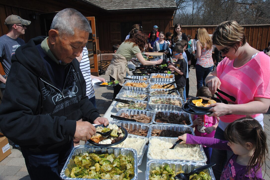 Guests make their way through the buffet lines during a volunteer appreciation picnic held May 15, 2014, at Turtle River State Park, N.D. The buffet-style meal of chicken Alfredo, beef strips, mashed potatoes and vegetables was part of the event coordinated by the 319th Air Base Wing Chapel staff, which was design to show the agency’s deep appreciation for community members and their families, who contributed more than 40,000 volunteer hours in 2013. (U.S. Air Force photo/Staff Sgt Luis Loza Gutierrez)