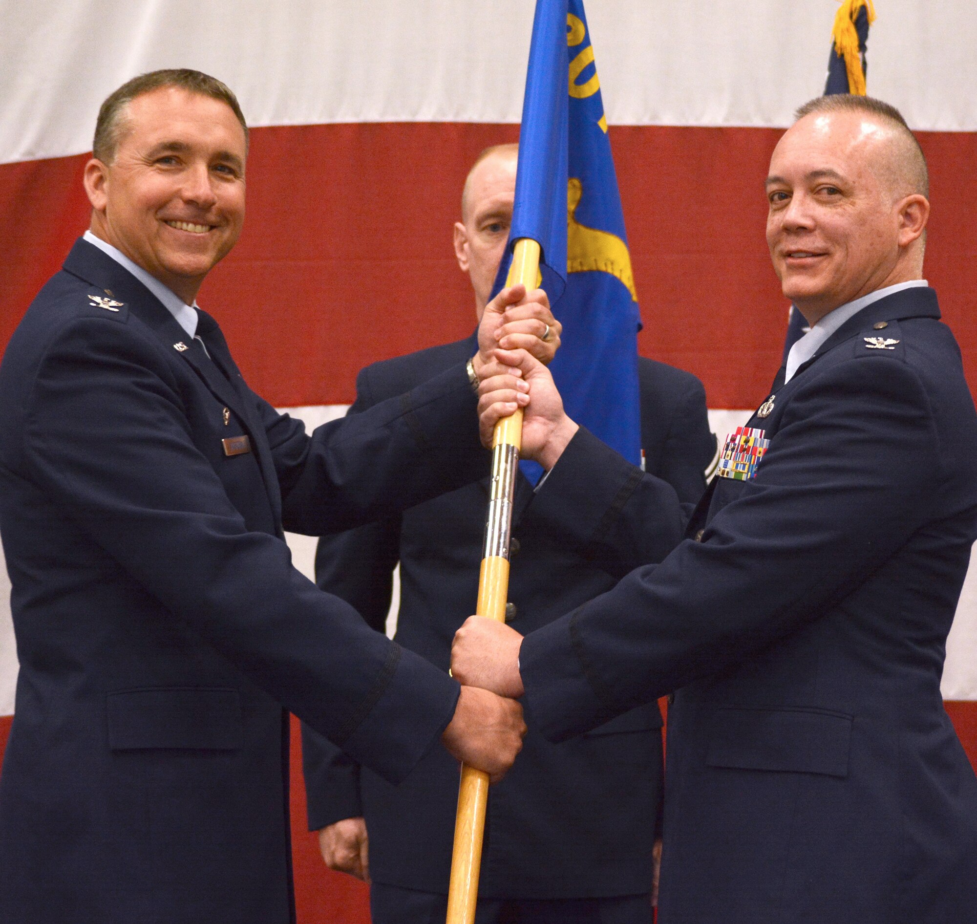 Col. John Breazeale, 301st Fighter Wing commander, passes the Mission Support Group guideon to Col. Jeffrey Barnett,  the new MSG commander, during a recent ceremony. Col. Barnett comes to the wing from the 442nd MSG at Whiteman Air Force Base, Mo. (U.S. Air Force photo/ SSgt. Samantha Mathison)