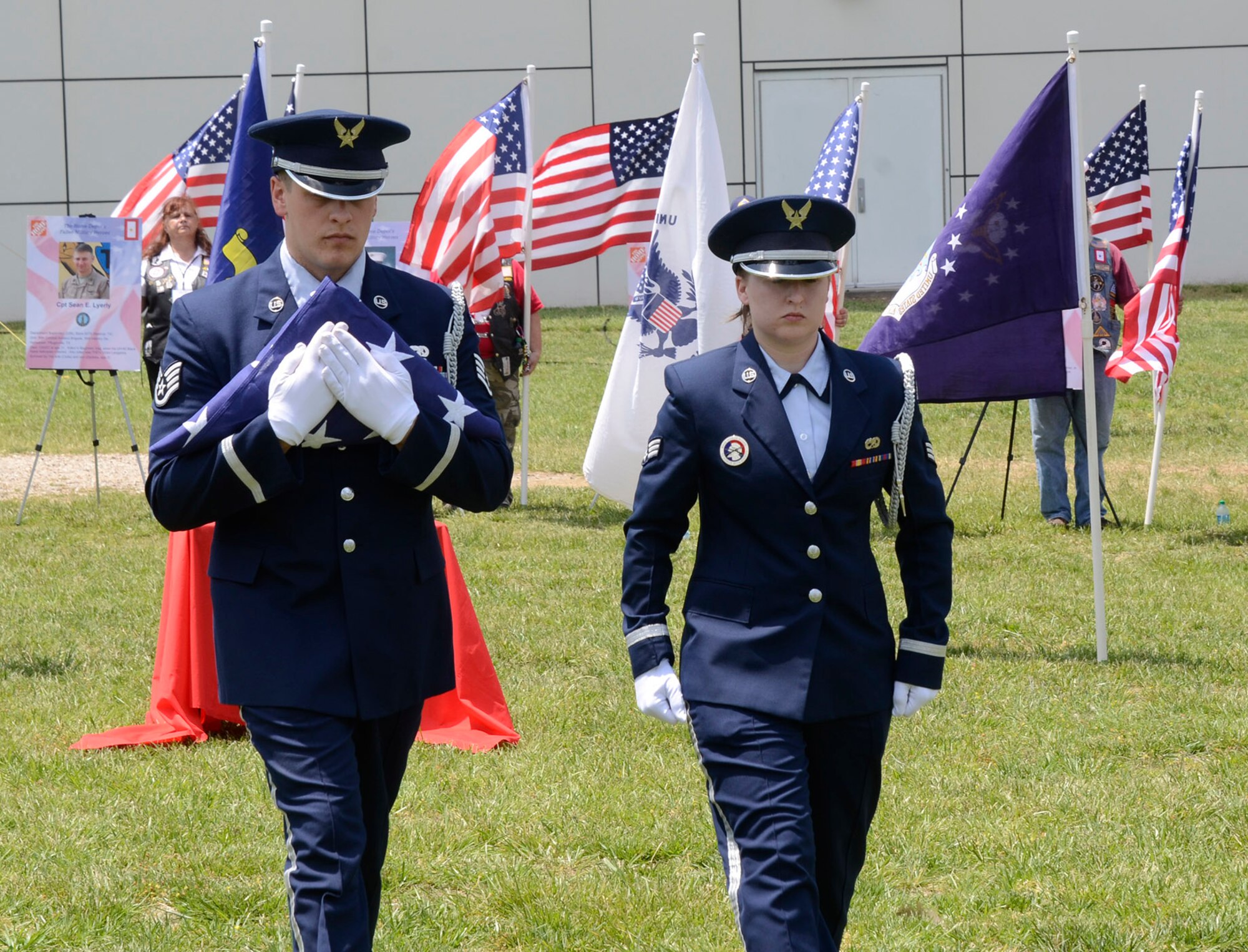 Staff Sgt. Joshua Koon and Senior Airman Kellie Creel, from the 94th Airlift Wing Honor Guard, Dobbins Air Reserve Base, Ga., perform a flag folding ceremony during a Military Appreciation Group luncheon sponsored by The Home Depot Corporate Headquarters, Atlanta, Ga. May 23, 2014. The program included Flag-Line demonstration by Patriot Guard Riders Association, Missing Man Table, and Fallen Heroes Bell Ceremonies. (U.S. Air Force photo/Don Peek)