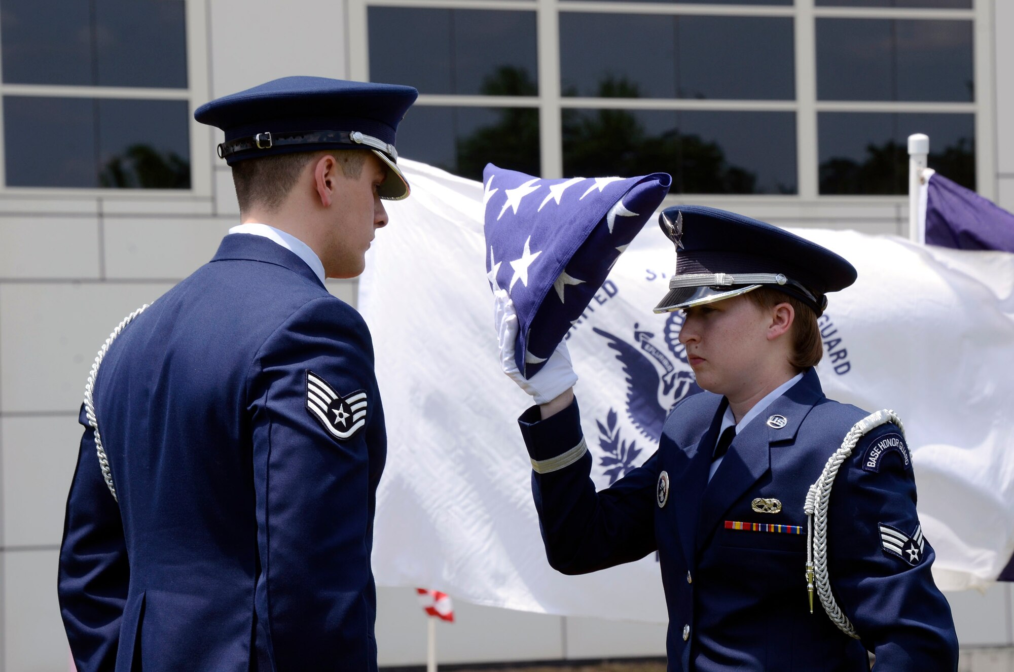 Staff Sgt. Joshua Koon and Senior Airman Kellie Creel, from the 94th Airlift Wing Honor Guard, Dobbins Air Reserve Base, Ga., perform a flag folding ceremony during a Military Appreciation Group luncheon sponsored by The Home Depot Corporate Headquarters, Atlanta, Ga. May 23, 2014. The program included Flag-Line demonstration by Patriot Guard Riders Association, Missing Man Table, and Fallen Heroes Bell Ceremonies. (U.S. Air Force photo/Don Peek)