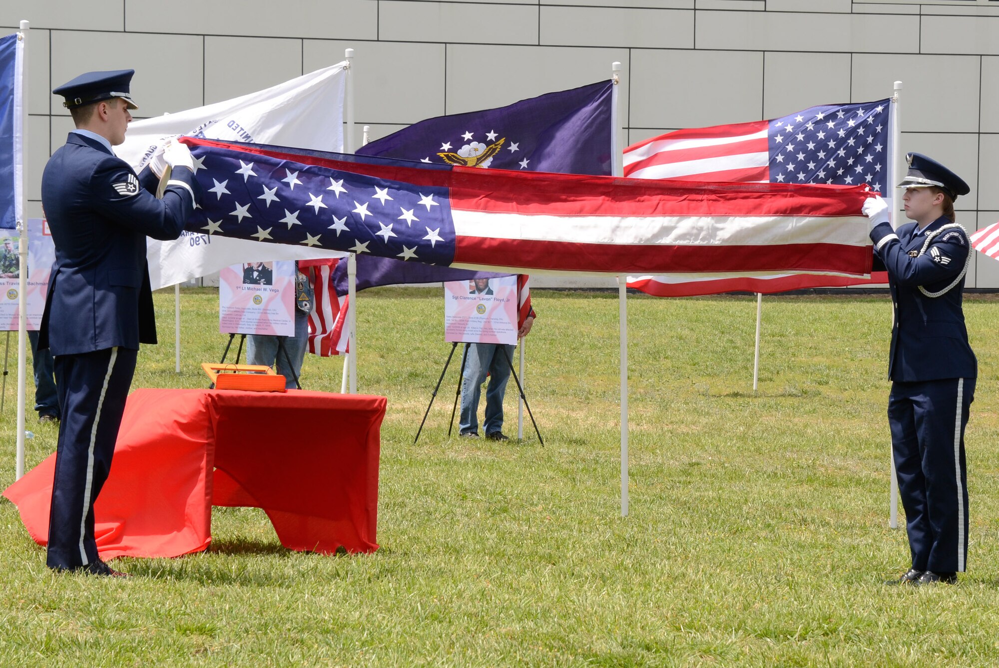 Staff Sgt. Joshua Koon and Senior Airman Kellie Creel, from the 94th Airlift Wing Honor Guard, Dobbins Air Reserve Base, Ga., perform a flag folding ceremony during a Military Appreciation Group luncheon sponsored by The Home Depot Corporate Headquarters, Atlanta, Ga. May 23, 2014. The program included Flag-Line demonstration by Patriot Guard Riders Association, Missing Man Table, and Fallen Heroes Bell Ceremonies. (U.S. Air Force photo/Don Peek)