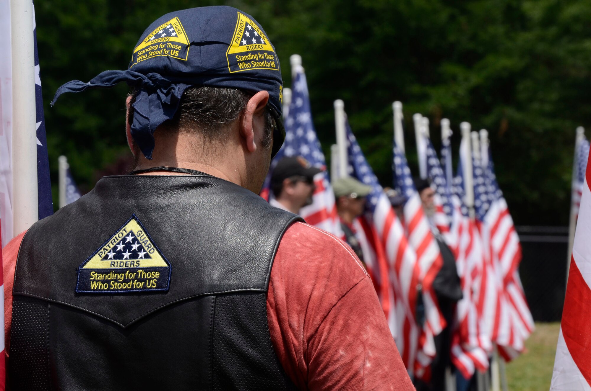 Patriot Guard Riders Association members stand a Flag-Line on ceremonial grounds arranged at The Home Depot Corporate Headquarters, Atlanta, Ga. for military honors demonstrations by Patriot Guard and a team from the 94th Airlift Wing Honor Guard, Dobbins Air Reserve Base, Ga. May 23, 2014, during a Military Appreciation Luncheon sponsored by the company. (U.S. Air Force photo/Don Peek)