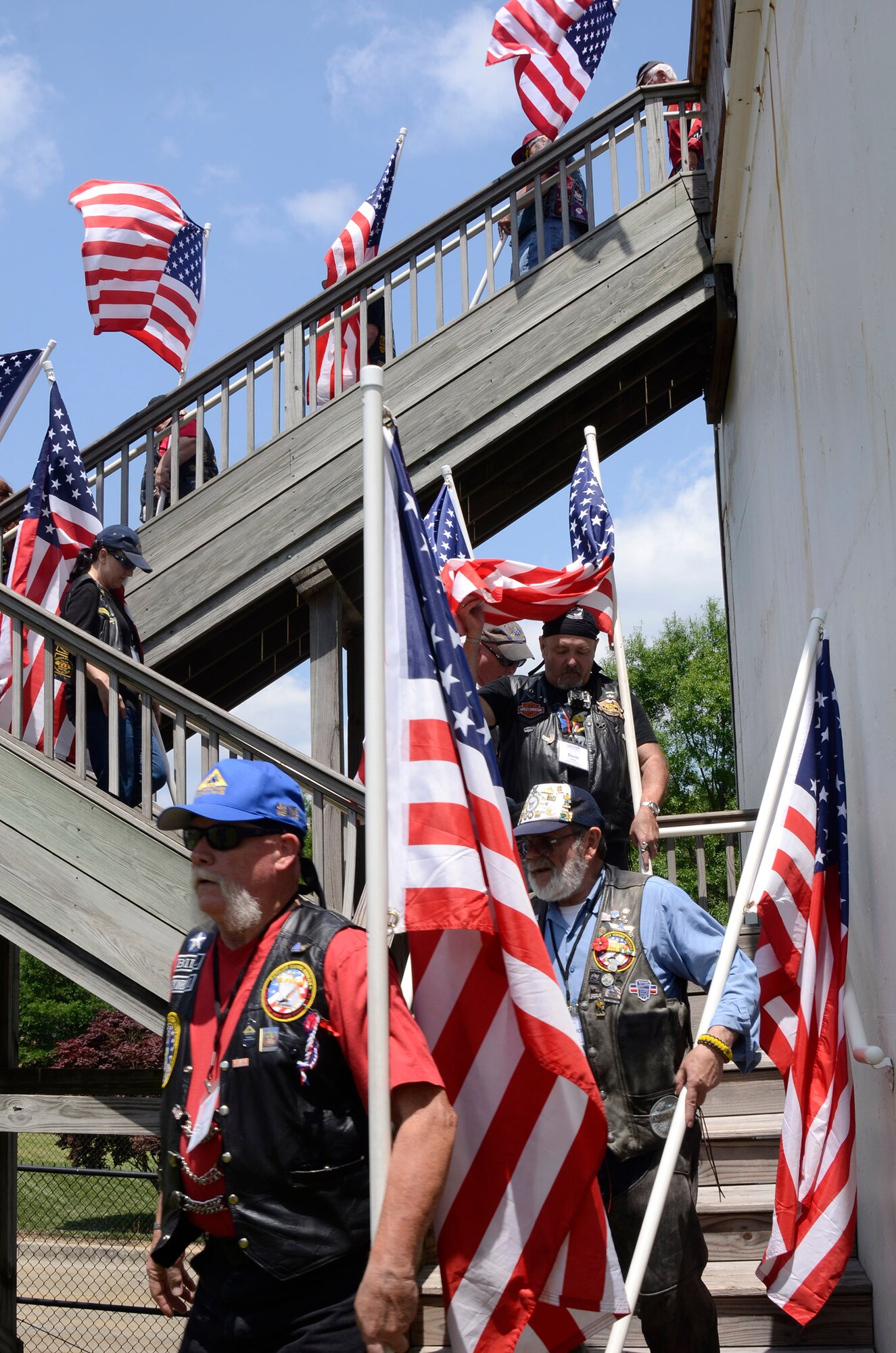 Patriot Guard Riders Association members Flag-Line, enter ceremonial grounds arranged at The Home Depot Corporate Headquarters, Atlanta, Ga. for military honors demonstrations by Patriot Guard and a team from the 94th Airlift Wing Honor Guard, Dobbins Air Reserve Base, Ga. May 23, 2014, during a Military Appreciation Luncheon sponsored by the company. (U.S. Air Force photo/Don Peek)