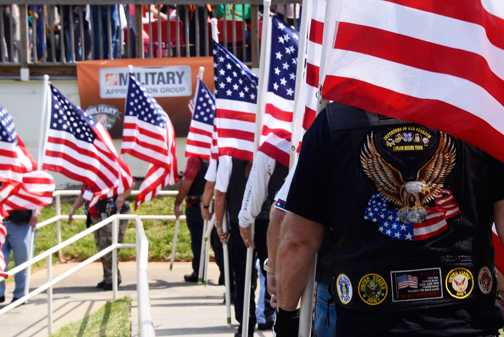 Patriot Guard Riders Association members Flag-Line, enter ceremonial grounds arranged at The Home Depot Corporate Headquarters, Atlanta, Ga. for military honors demonstrations by Patriot Guard and a team from the 94th Airlift Wing Honor Guard, Dobbins Air Reserve Base, Ga. May 23, 2014, during a Military Appreciation Luncheon sponsored by the company. (U.S. Air Force photo/Don Peek)