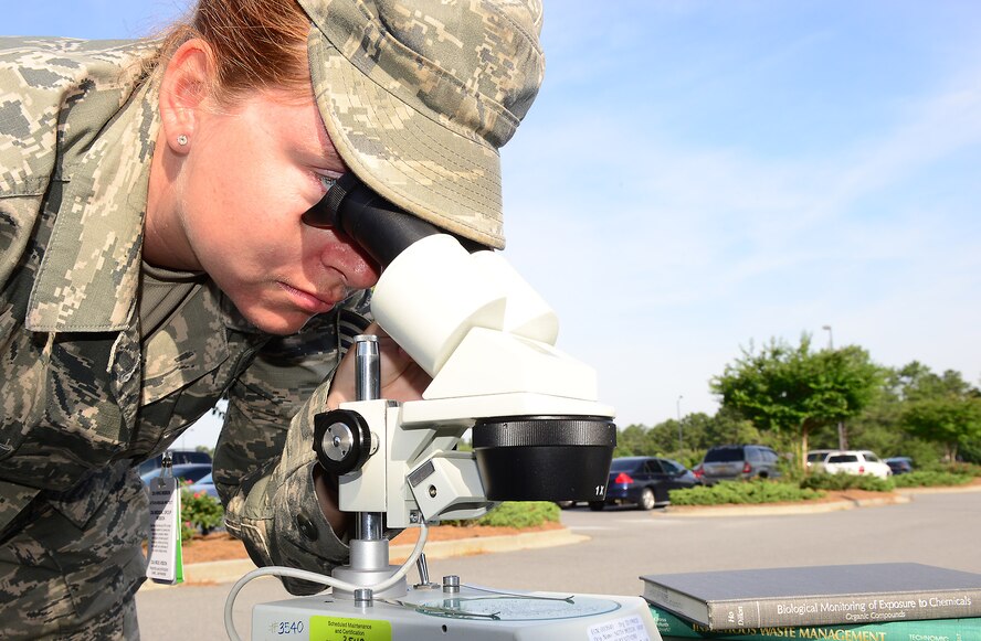 U.S. Air Force Tech. Sgt. Kristi Gillespie, 23d Aerospace Medicine Squadron NCO in charge of occupational health, uses a microscope to look at magnesium chloride, a substance used in salt water aquariums, at Moody Air Force Base, Ga., May 29, 2014. Bioenvironmental Airmen use the powder for training purposes, although this type of training is generally done at the U.S. Air Force School of Aerospace Medicine level. (U.S. Air Force photo by Senior Airman Tiffany M. Grigg/Released) 