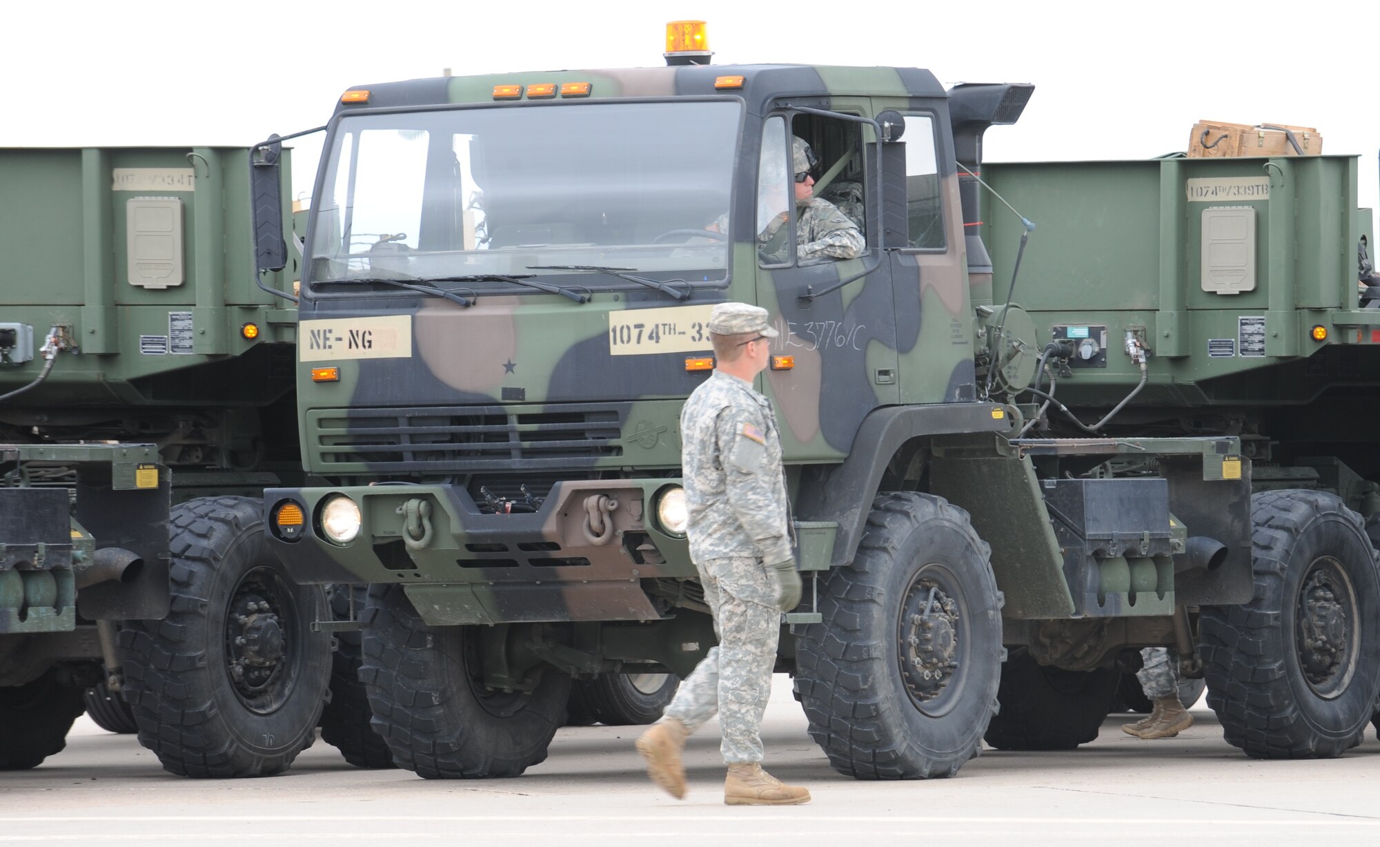 Soldiers assigned to the 1074th Transportation Company, Nebraska National Guard, Sidney, Neb., prepare a vehicle convoy to transport lumber during South Dakota National Guard's Golden Coyote exercise June 12, 2013. People working and living on or near the base should be prepared for increased military vehicle traffic, especially at the intersection of West Gate Road and Highway 14-16, during the 30th annual training exercise June 7 to 21, 2014. (U.S. Air Force photo by Senior Airman Alystria Maurer/Released)


