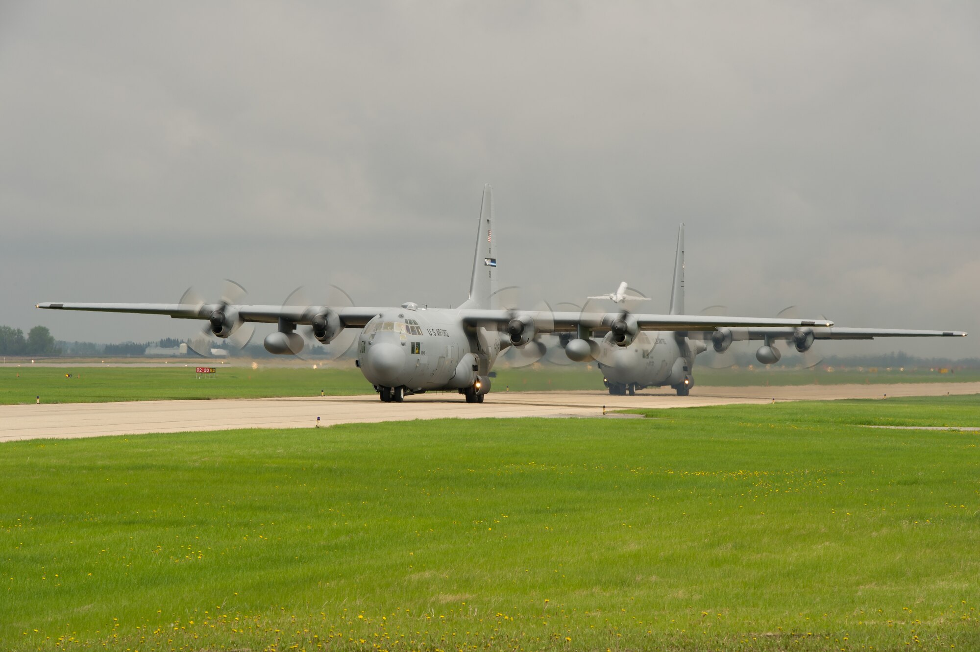 U.S. Air Force C-130 Hercules aircraft taxi on the taxiway during Maple Flag 47 in Edmonton/Cold Lake, Alberta, Canada, May 26, 2014. Maple Flag is an international exercise designed to enhance the interoperability of C-130 aircrews, maintainers and support specialists in a simulated combat environment. (U.S. Air Force photo by Tech. Sgt. Matthew Smith/Released)