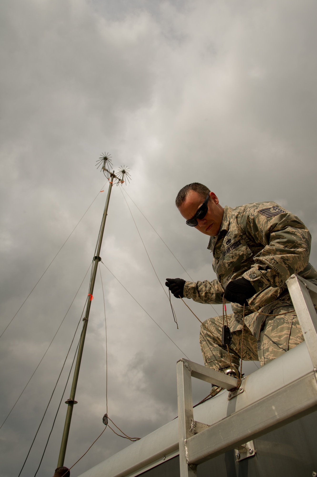 U.S. Air Force Tech. Sgt. Sebastian Pineiro, aerial porter, 81st Aerial Porter Squadron, Joint Base Charleston, S.C., secures a guyline for a line-of-sight radio antenna to a communications trailer during Maple Flag 47 in Edmonton/Cold Lake, Alberta, Canada, May 26, 2014. Maple Flag is an international exercise designed to enhance the interoperability of C-130 aircrews, maintainers and support specialists in a simulated combat environment. (U.S. Air Force photo by Tech. Sgt. Matthew Smith/Released)