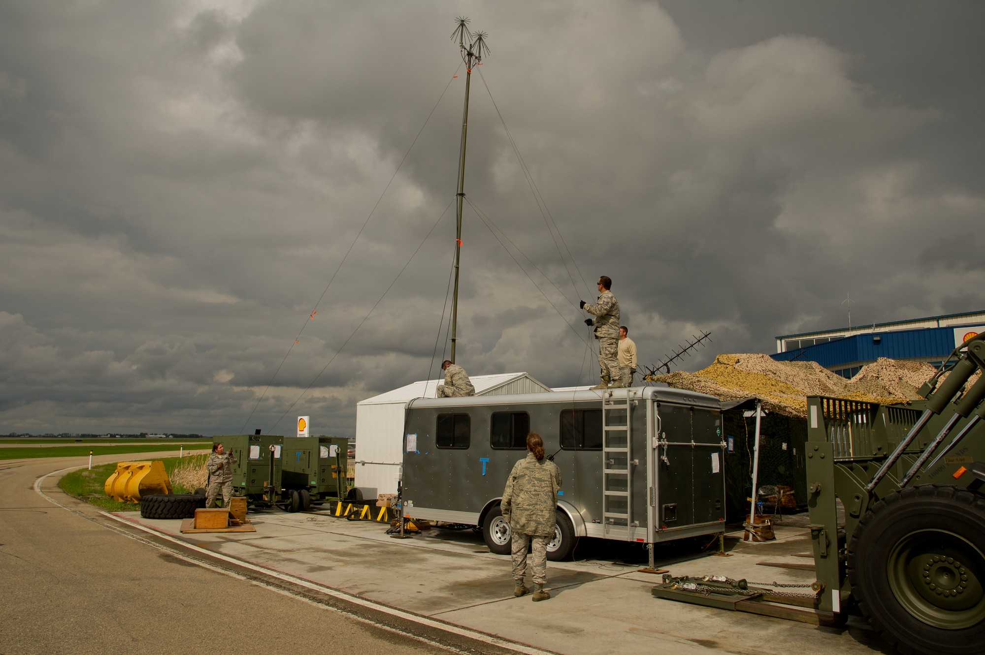 U.S. Air Force Airmen set up a line-of-sight radio antenna on top of a communications trailer during Maple Flag 47 in Edmonton/Cold Lake, Alberta, Canada, May 26, 2014. Maple Flag is an international exercise designed to enhance the interoperability of C-130 aircrews, maintainers and support specialists in a simulated combat environment. (U.S. Air Force photo by Tech. Sgt. Matthew Smith/Released)