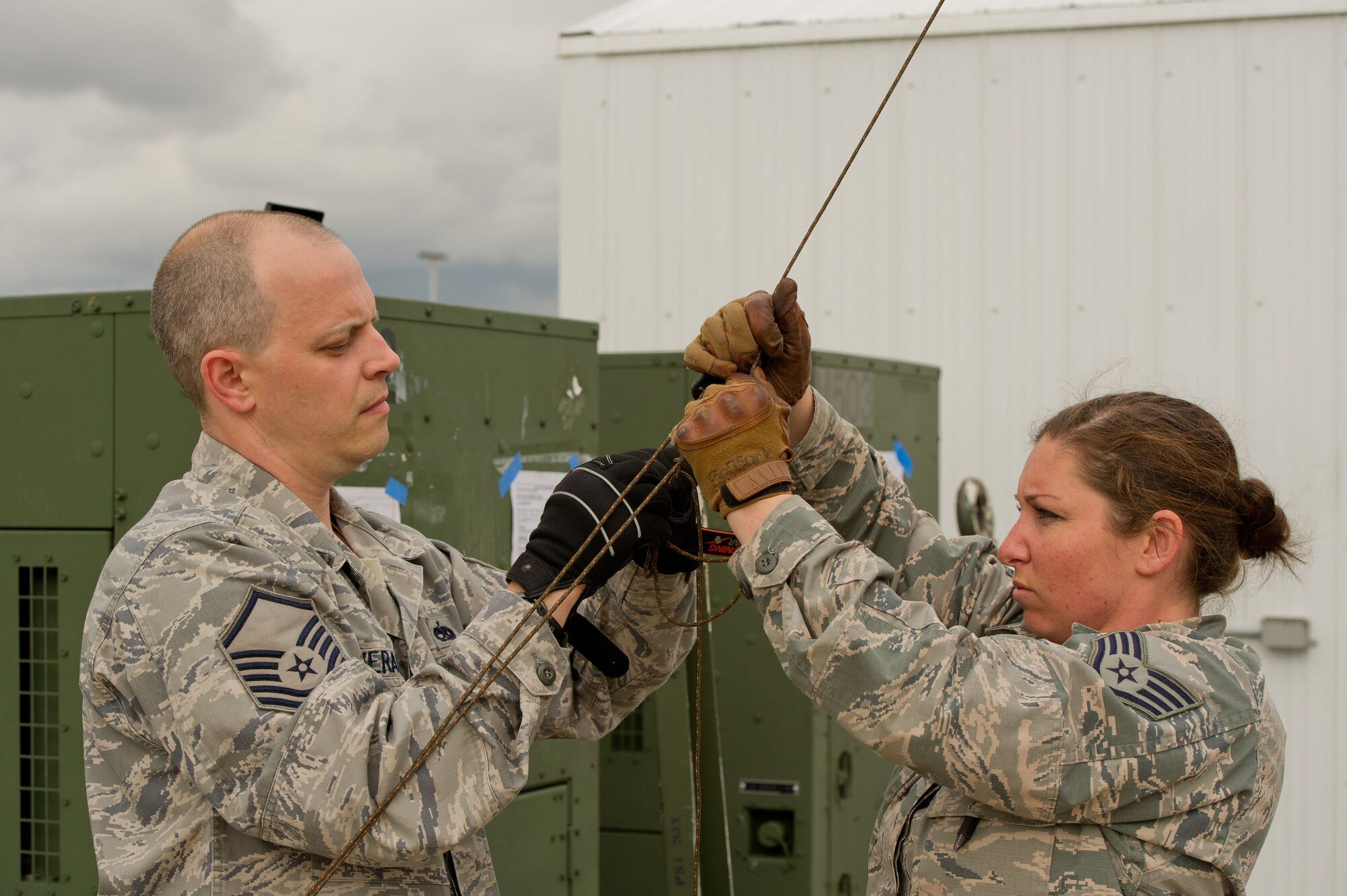U.S. Air Force Master Sgt. Joe Verant, and Staff Sgt. Jessica Bonsack, communications craftsman, both with the 315th Airlift Control Flight, Joint Base Charleston, S.C.,  secure a guyline for a line-of-sight radio antenna during Maple Flag 47 in Edmonton/Cold Lake, Alberta, Canada, May 26, 2014. Maple Flag is an international exercise designed to enhance the interoperability of C-130 aircrews, maintainers and support specialists in a simulated combat environment. (U.S. Air Force photo by Tech. Sgt. Matthew Smith/Released)