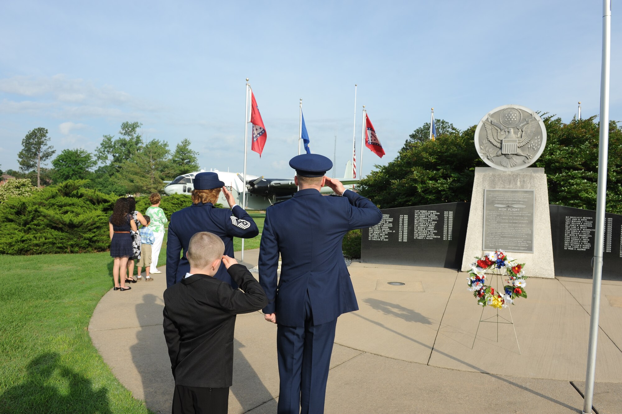 Team Little Rock leadership and families salute the flag May 26, 2014, at Little Rock Air Force Base, Ark. This time-honored military tradition commemorates Memorial Day, first known as Decoration Day, and honors the men and women who have died while serving in the military. (U.S. photo by Airman 1st Class Scott Poe)