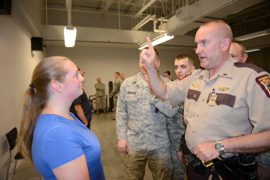 Minnesota State Trooper Dean Grothem demonstrates field sobriety testing techniques on Amanda Millsap for 934th Security Forces Squadron members. Grothem is also a senior master sgt. loadmaster with the 96th Airlift Squadron in his Air Force Reserve job.  (Air Force Photo/Paul Zadach) 