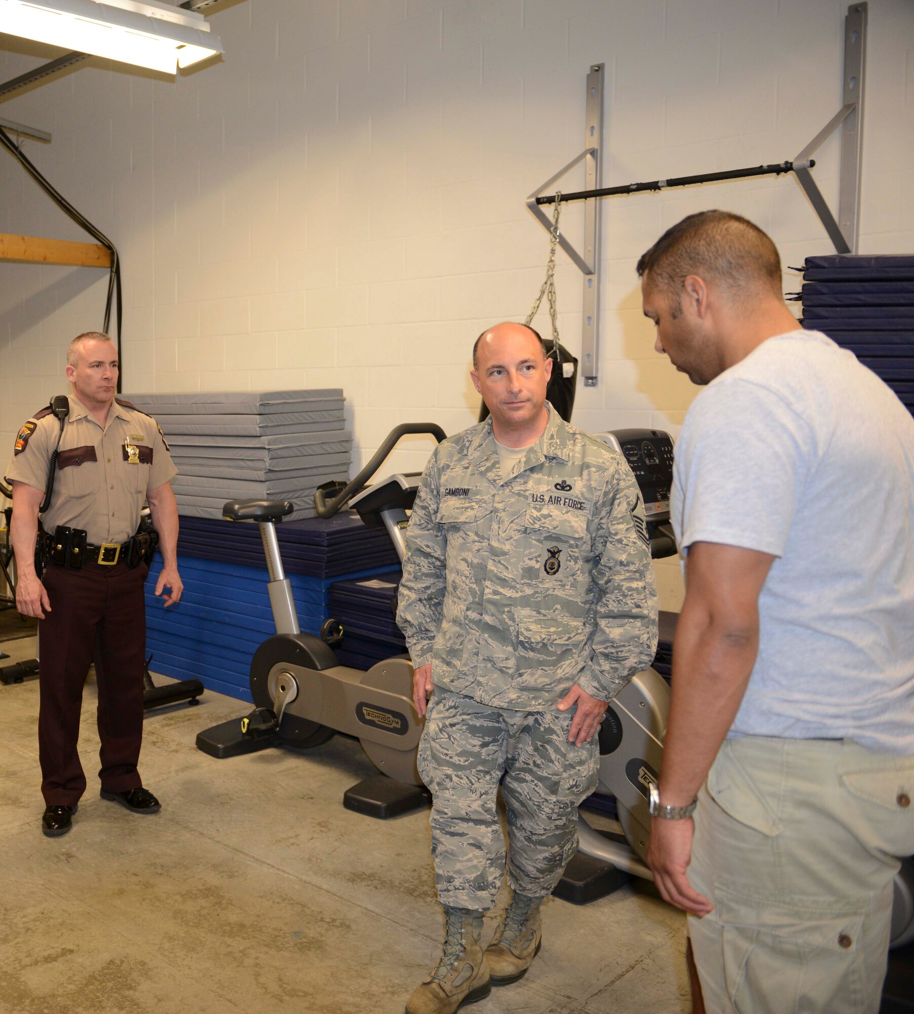 Minnesota State Trooper Lt. Chris Erickson  and Master Sgt. Anthony Gamboni, 934th Security Forces Squadron, administer a field sobriety test to John Brown during DUI recognition training May 29. (Air Force Photo/Paul Zadach) 