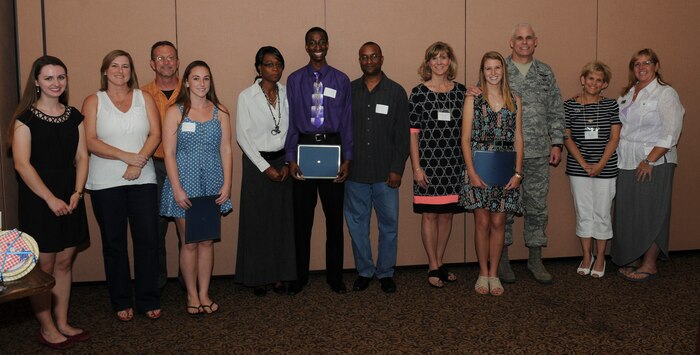 Beale Officers’ Spouses’ Club scholarship recipients and their families pose for a photo during the BOSC annual banquet at the Recce Point Club on Beale Air Force Base, Calif., May 27, 2014. The recipients were chosen based on academic achievements, extracurricular activities, community involvement, letters of recommendation and an essay. (U.S. Air Force photo by Airman 1st Class Michael Hunsaker/Released)