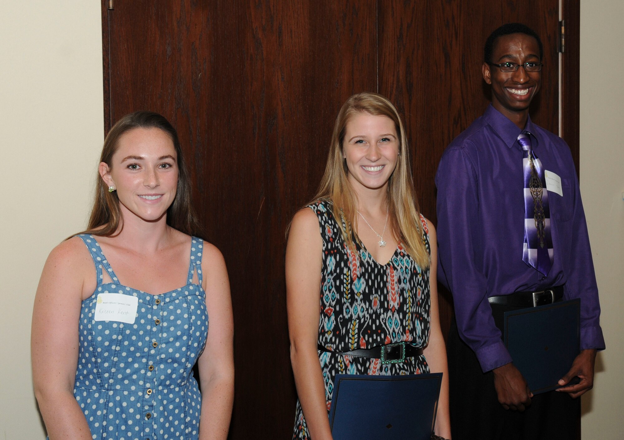 Kristen Kent (left), Kararlynn Sipowicz (middle) and Donovan Young (right) hold their scholarships at the Recce Point Club on Beale AFB, Calif., May 27, 2014. The $8,000 in scholarship funds this year was raised by the Beale Officers' Spouses' Club throughout the year through fundraising efforts and the Beale Thrift Shop. (U.S. Air Force photo by Airman 1st Class Michael Hunsaker/Released) 