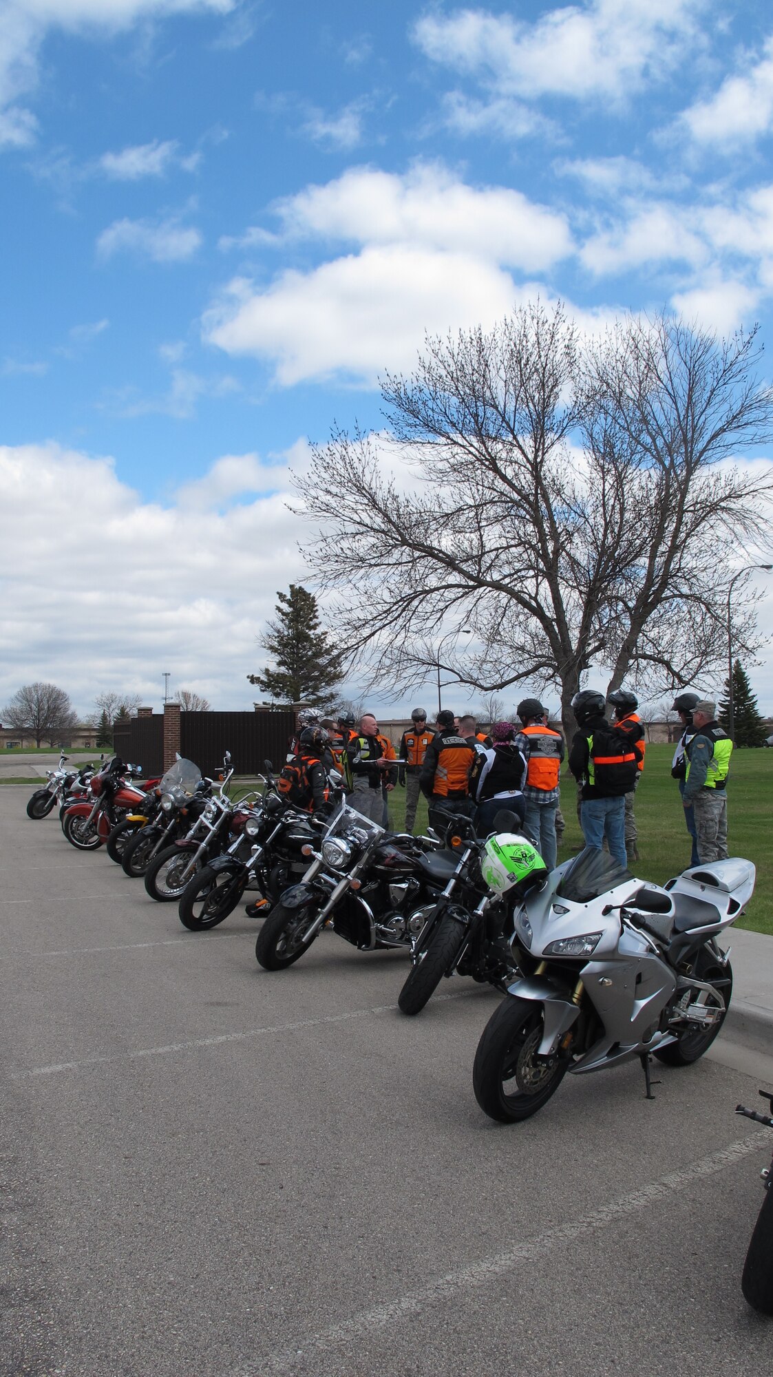 (At center wearing a neon reflective motorcycle vest) Tech. Sgt. John Oldham from the 319th Air Base Wing Safety Office takes accountability and does one last safety briefing before a group ride on the flightline of Grand Forks Air Force Base, N.D., which took place May 21, 2014. The group ride on the flightline included a group photo in front of a stationary RQ-4 Block 40 Global Hawk. It was coordinated by the 319th Air Base Wing Safety Office, the 69th Reconnaissance Group and the 319th Operation Support Squadron. (U.S. Air Force photo/Tech. Sgt. Laurie Creek)