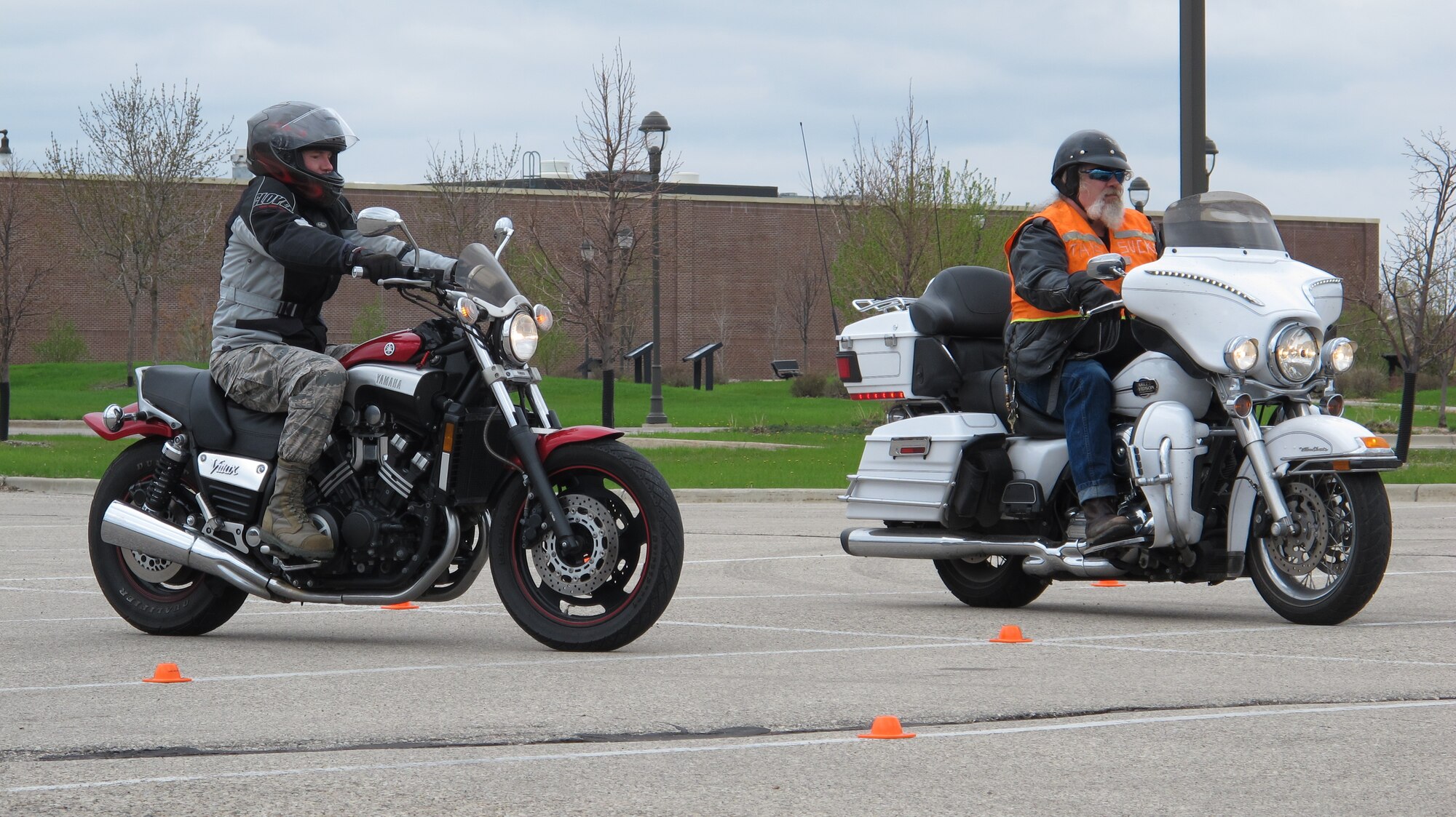 (From left to right)  Riders try to maintain their balance as they compete in a motorcyle slow race May 21, 2014, at Commuity Activity Center's parking lot on Grand Forks Air Force Base, N.D. The slow race was one of several events designed to raise awareness and promote responsible rider training and good habits during the 2014 Motorcycle Safety Days, which took place May 19-21 and was coordinated by the 319th Air Base Wing Safety Office. (U.S. Air Force photo/Tech. Sgt. Laurie Creek)