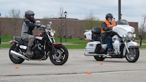 (From left to right)  Riders try to maintain their balance as they compete in a motorcyle slow race May 21, 2014, at Commuity Activity Center's parking lot on Grand Forks Air Force Base, N.D. The slow race was one of several events designed to raise awareness and promote responsible rider training and good habits during the 2014 Motorcycle Safety Days, which took place May 19-21 and was coordinated by the 319th Air Base Wing Safety Office. (U.S. Air Force photo/Tech. Sgt. Laurie Creek)