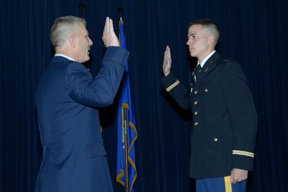 Col. Kyle 'Cowboy' Ingham administers the oath of office to 2nd
Lt. Austin Ingham during ceremonies celebrating the colonel's retirement and
his son's commissioning on May 20 at Joint Base-Randolph, Texas. (Air Force photo by Joel Martinez)
