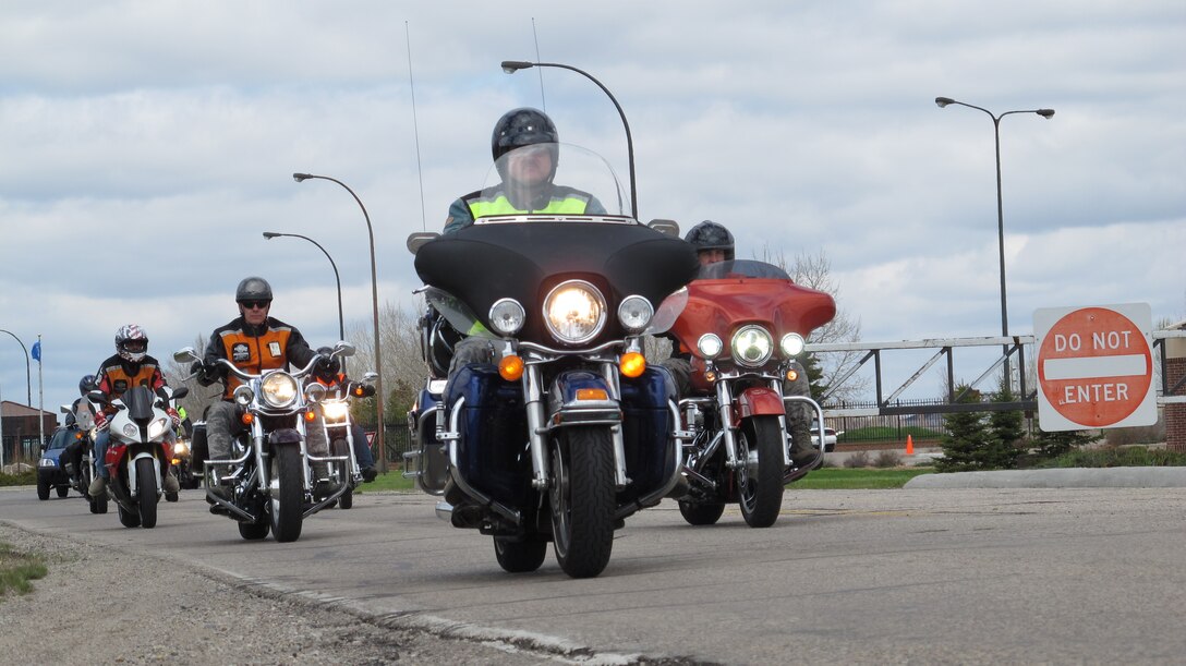 (From left to right)  Chief Master Sgt. Marc Schoellkopf, Master Sgt. Lance Savage and Maj. Frank Burks, ride in exit Grand Forks Air Force Base, N.D. while riding in staggered formation during a Mentorship Ride, which took place May 21, 2014. The mentorship ride was one of several events designed to raise awareness and promote responsible rider training and good habits during the 2014 Motorcycle Safety Days coordinated by the 319th Air Base Wing Safety Office. (U.S. Air Force photo/Tech. Sgt. Laurie Creek)