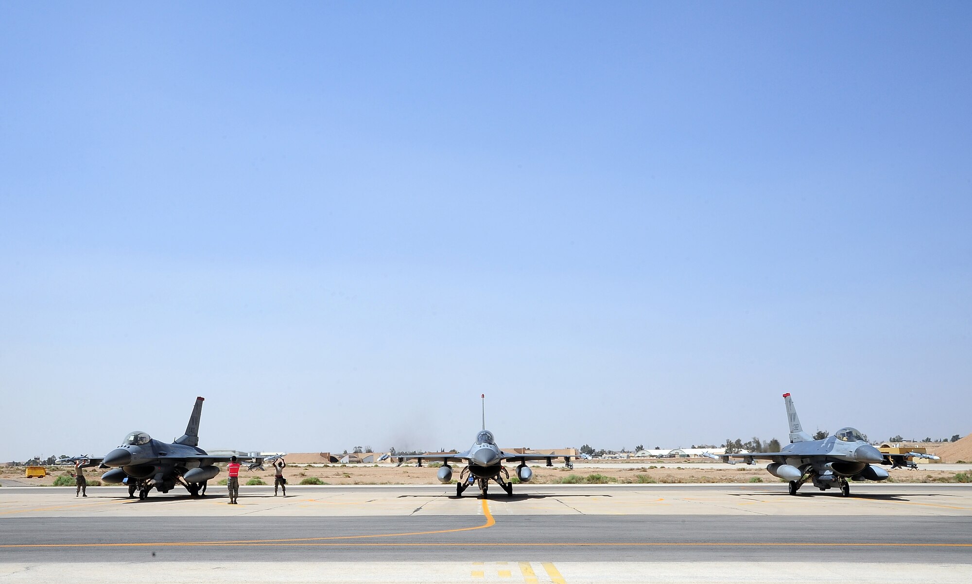 Maintainers assigned to the 13th Aircraft Maintenance Unit at Misawa Air Base, Japan, prepare an F-16 Fighting Falcon for flight during Exercise Eager Lion May 27, 2014, at an air base in northern Jordan. This year, more than 12,500 personnel from more than 20 nations are participating in the exercise, which is designed to strengthen military-to-military relationships and interoperability. (U.S. Air Force photo by Staff Sgt. Brigitte N. Brantley/Released)