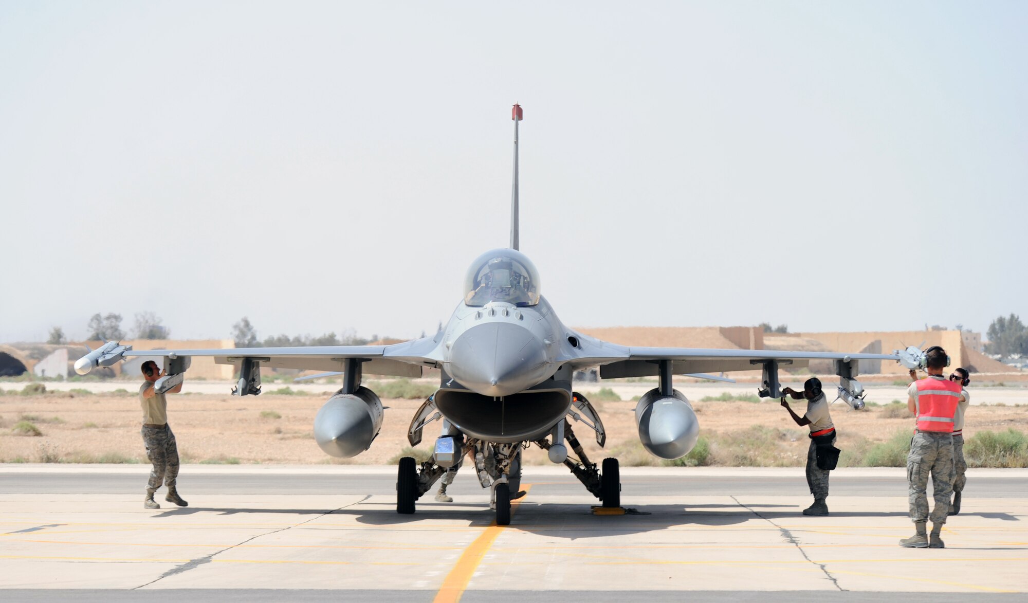 Maintainers assigned to the 13th Aircraft Maintenance Unit at Misawa Air Base, Japan, prepare an F-16 Fighting Falcon for flight during Exercise Eager Lion May 27, 2014, at an air base in northern Jordan. Airmen from several maintenance career fields, from avionics to crew chiefs, are responsible for launching the jets which will fly alongside coalition partners. This year, more than 12,500 personnel from more than 20 nations are participating in the exercise, which is designed to strengthen military-to-military relationships and interoperability. (U.S. Air Force photo by Staff Sgt. Brigitte N. Brantley/Released)