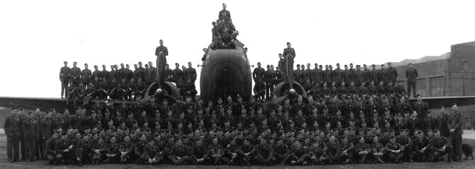 Members of the 37th Troop Carrier Squadron gathered for a group photo in front of a Douglas C-47 Skytrain, designated Whiskey 7, on RAF Cottesmore, England in 1944. The 37th Airlift Squadron recreated the historical photo to honor their squadron’s origin. (Courtesy photo)